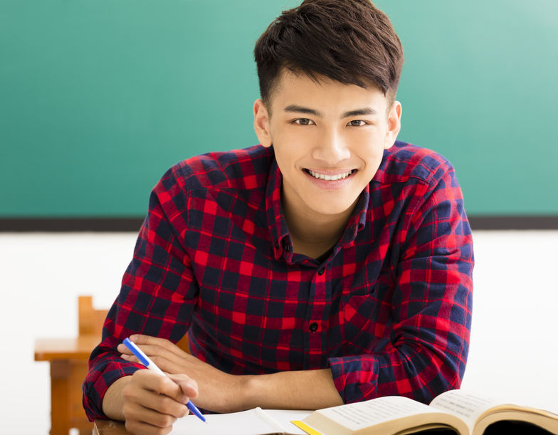 Smiling college student in university classroom