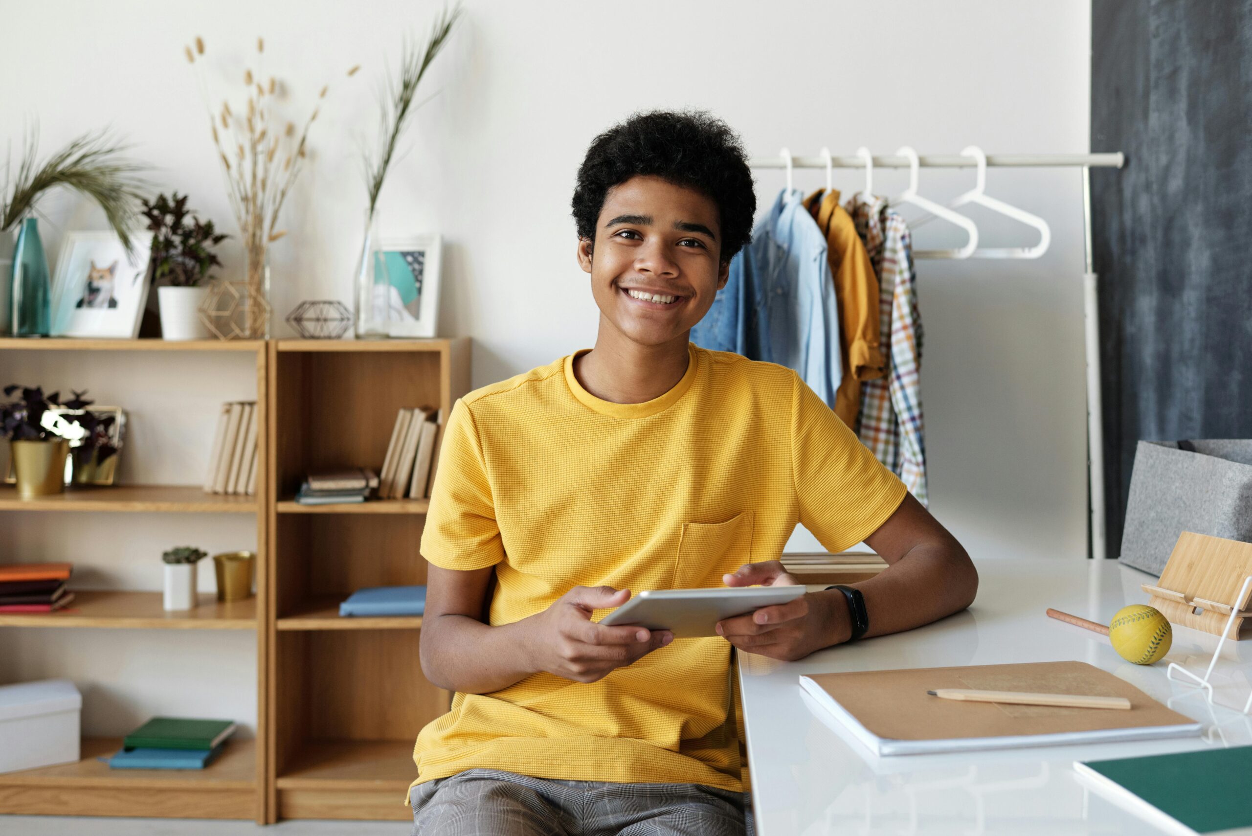 Teen Smiling tablet phone screen time social media technology alpha generation internet safety online tweens and teens